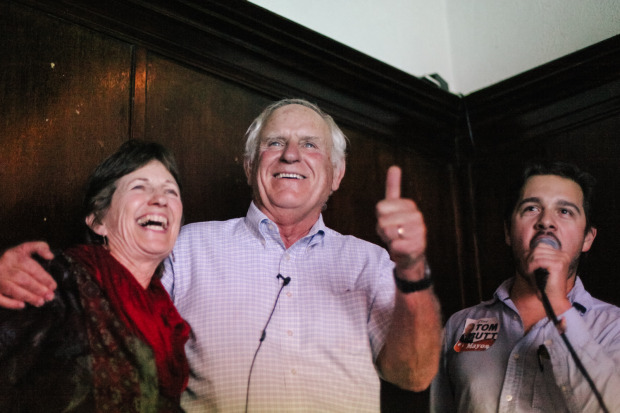 Tom Butt (center), with his wife and campaign manager, reacts as unofficial election results show him winning Richmond's mayoral seat. (Photo by Bonnie Chan)